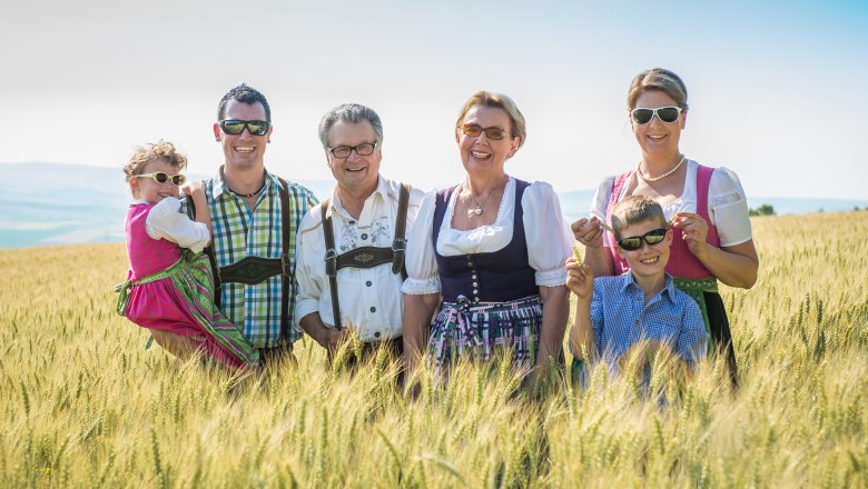 The Hopfeld family in traditional costume in a field.