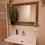 Bathroom with washbasin, mirror, towel rail and plant.