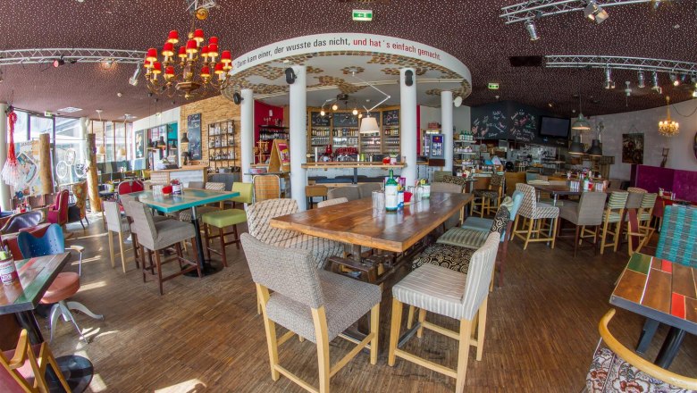 Interior of a stylish caf&eacute; with wooden furniture and decorative elements.
